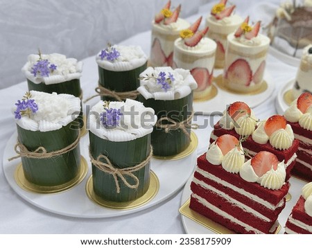 Home made cake on white background. Strawberry cream cheese cake. 
cheesecake on a wooden plate. Fresh  Strawberry topping with cream and thyme leaves. Bakery picture free space for text.
