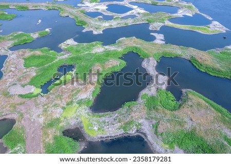 Aerial footage of the River Bhima and surrounding landscape including bridges at Daund India. Royalty-Free Stock Photo #2358179281
