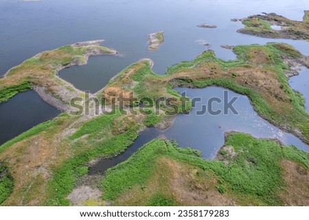 Aerial footage of the River Bhima and surrounding landscape including bridges at Daund India. Royalty-Free Stock Photo #2358179283