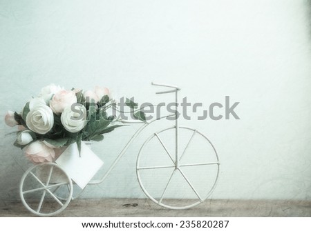 sweet roses soft color on bicycle, vintage style background