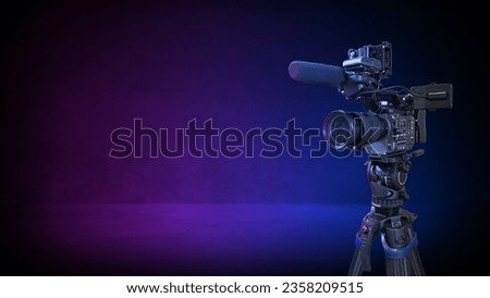 professional digital video camera on pink and blue concret room background. TV broadcast or movie production banner with copy space