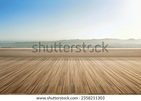 Rooftop patio with wooden floor with a view of the landscape and blue sky background