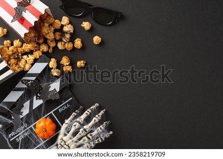 Dive into spooky cinema vibes on Halloween night, viewing above-view picture of cinema essentials and eerie Halloween decorations on a black isolated background, perfect for your advertising messages