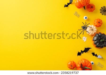 Experience charm of spooky Halloween evening. Top-view snapshot presenting pumpkins, spiders, human eyes, and Halloween decorations on a yellow isolated backdrop, copy-space for advertising or text.