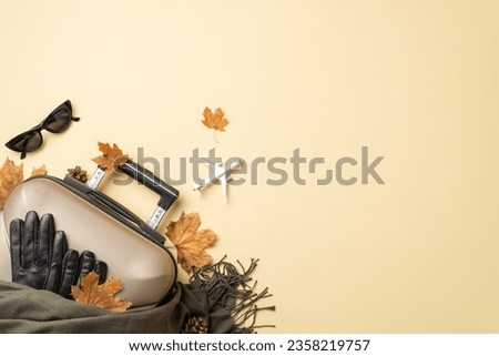 Autumn elegance boarding plane. Top view of aircraft, adorned with chic autumn accessories: cat-eye shades, woolen scarf, leather gloves, suitcase, leaves on yellow backdrop, space for text or advert
