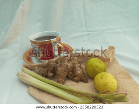 Herbs for health, a cup of herbal drink made from ginger, lemongrass and lime, on white background, natural medicine and naturopathy concept.