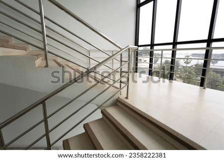 Empty stairs with metal handrails and windows in  modern interior building Royalty-Free Stock Photo #2358222381
