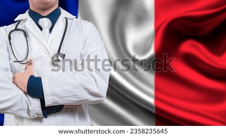Doctor with stethoscope on France flag. Doctor with arms crossed on France flag background. Medical health and care on French flag