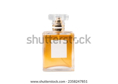 Square glass bottle with orange perfume inside isolate on white background with clipping path.Perfume bottle with blank label for text.luxury glass bottle.