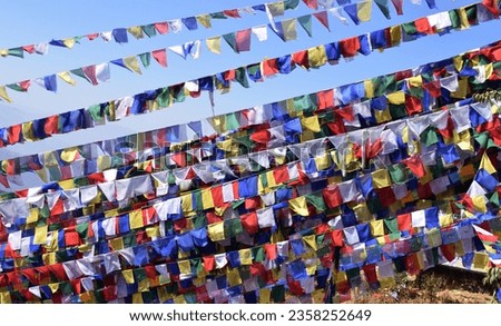 A Buddhist prayer flag is a colorful rectangular cloth that can be spotted on high Himalayan peaks. They are used to bless everywhere.