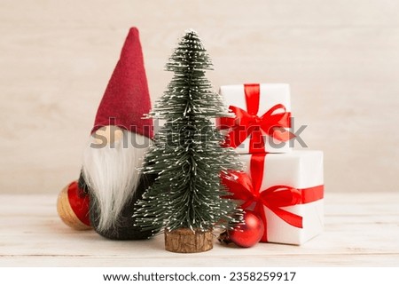 Miniature christmas tree with gift boxes and decor on table