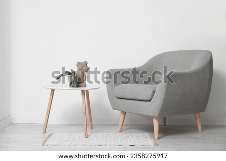 Interior of living room with plant on table and armchair Royalty-Free Stock Photo #2358275917