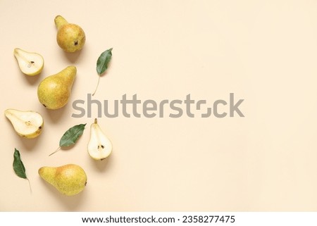 Ripe pears and leaves on yellow background Royalty-Free Stock Photo #2358277475