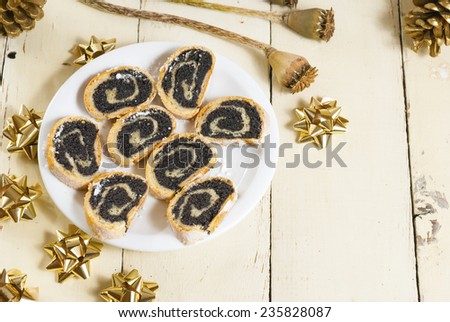 sliced poppy seed rolls on rusty old wooden table