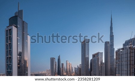 Aerial sunrise view of Dubai Downtown skyline with many towers night to day transition timelapse. Business area in smart urban city. Skyscrapers and high-rise buildings from above early morning, UAE. Royalty-Free Stock Photo #2358281209