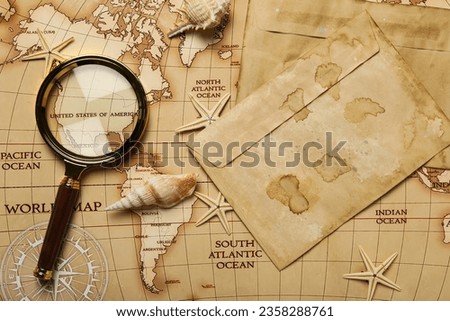 Columbus Day. Magnifying glass and old envelopes on the map of America
