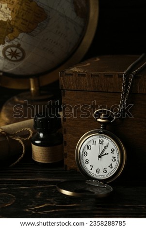 Columbus Day. Globe with a pocket watch on a dark background