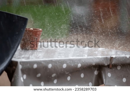 Rain falling on the outside table
