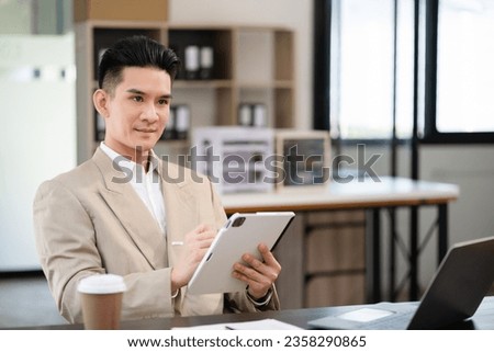 Young man sitting at his desk in the office