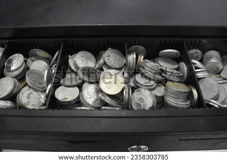 The cash drawer contains rupiah coins