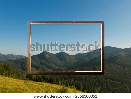 Wooden frame and beautiful mountains under blue sky