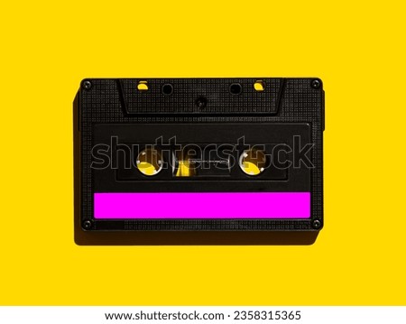 Audio cassette on a yellow background. View from above. Flat lay.