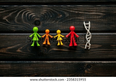DNA molecule with rubber figurines of people. Heredity of family members. Royalty-Free Stock Photo #2358315955