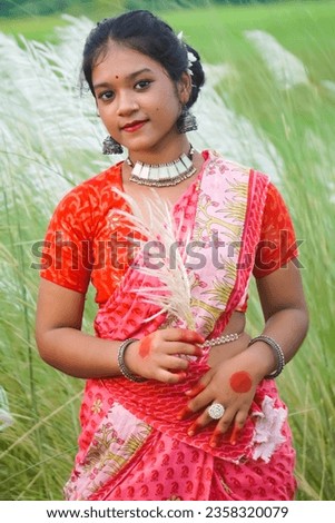 A beautiful Indian teenage girl doing a photo shoot in Kashful field. Baruipur West Bengal India September 7-2023.