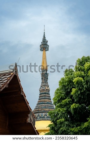 Beautiful ancient Wat Buppharam Temple is a Buddhist temple that is more than 400 years old with wooden church decor by glass inlay of Lanna style.  Historic temple in Chiang Mai, North Thailand. Royalty-Free Stock Photo #2358320645