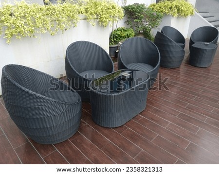 Tables and chairs made of rattan with glass bottoms in a hotel