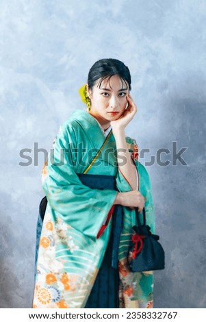 Portrait of an Asian woman wearing furisode and hakama. Japanese traditional dress. Pre-photoshoot at a photo studio for graduation ceremonies or coming-of-age ceremonies. Oriental beautiful woman.