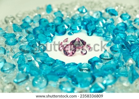 
A group of pink diamonds arranged in the middle of blue diamonds in a white background.
Top view of pink diamonds. white gems background video 4K.
Pink diamonds in heart shape and different size
