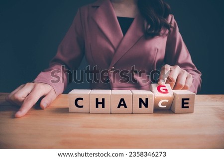 Businesswoman hand flipping wooden blocks with CHANGE to CHANCE text. Economy investment business crisis, technology transformation can make good chance, strategy, solution, positive thinking concept.