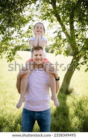 father with daughter outdoor in the green nature