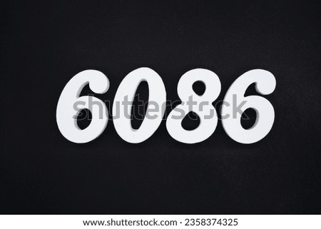 Black for the background. The number 6086 is made of white painted wood.