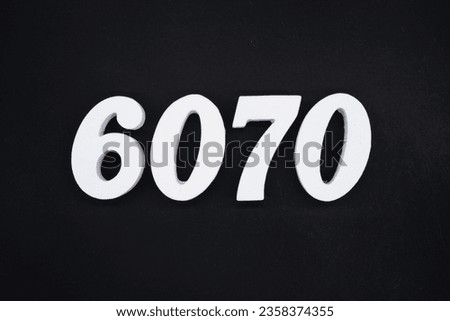 Black for the background. The number 6070 is made of white painted wood.
