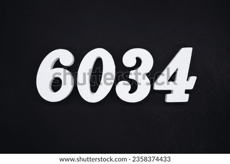 Black for the background. The number 6034 is made of white painted wood.