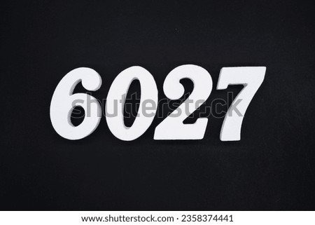 Black for the background. The number 6027 is made of white painted wood.