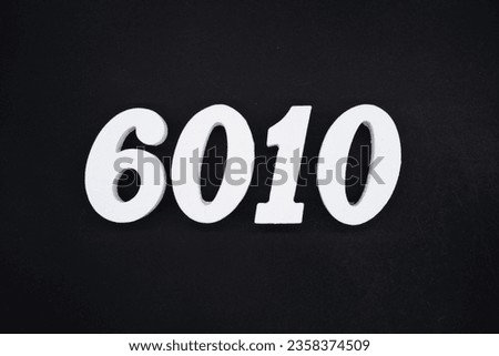 Black for the background. The number 6010 is made of white painted wood.
