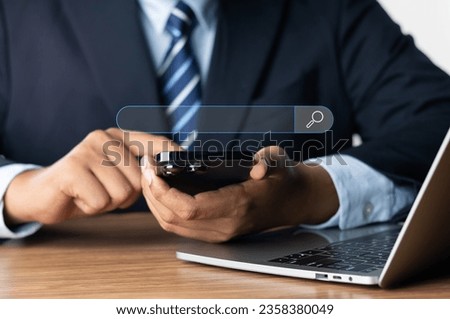 Searching Browsing Internet Data Information Networking Concept, Businessman use phone and laptop screen a search box for information on the Internet. finding data, Using Search Console with website.