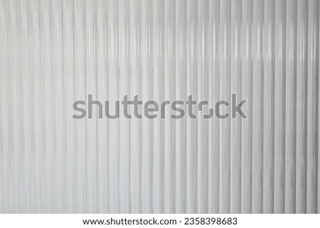 A Close up of corrugated glass texture with reflected,modern home decor,stylish home decor,Creative composition of living room,Wave glass vertical line pattern,Template. Royalty-Free Stock Photo #2358398683