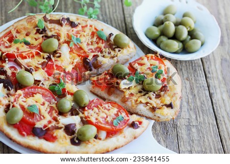 homemade pizza with mushrooms, olives and oregano