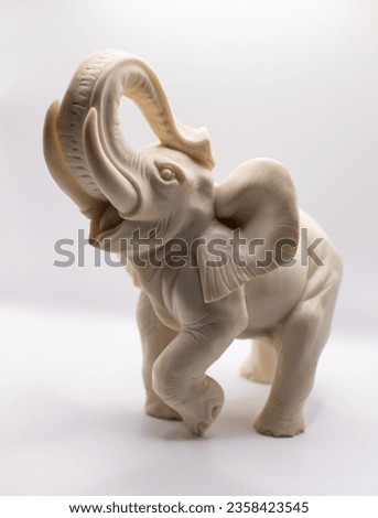 Ivory statue of an elephant on a white background