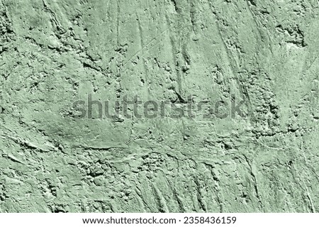 Green stone texture close-up. Rough green stone wall. Natural rock texture