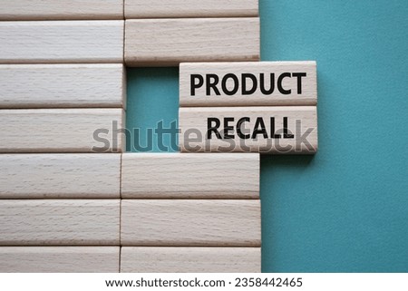 Product recall symbol. Concept words Product recall on wooden blocks. Beautiful grey green background. Business and Product recall concept. Copy space.