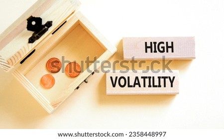 High volatility symbol. Concept words High volatility on beautiful wooden blocks. Beautiful white table white background. Wooden chest with coins. Business high volatility concept. Copy space.
