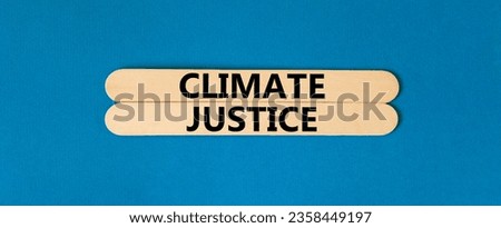 Climate justice symbol. Concept words Climate justice on beautiful wooden stick. Beautiful blue table blue background. Business environment climate justice concept. Copy space.