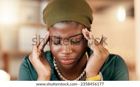 Headache, stress and burnout with a business black woman suffering from tension while working in her office. Anxiety, mental health and pain with a female employee rubbing her temples in discomfort