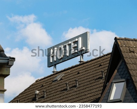 Hotel sign on a rooftop. Big advertisement for the hospitality service. Business in the tourism and travel industry.