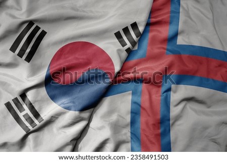 big waving national colorful flag of south korea and national flag of faroe islands . macro